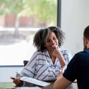 Mature businesswoman talks with male colleague