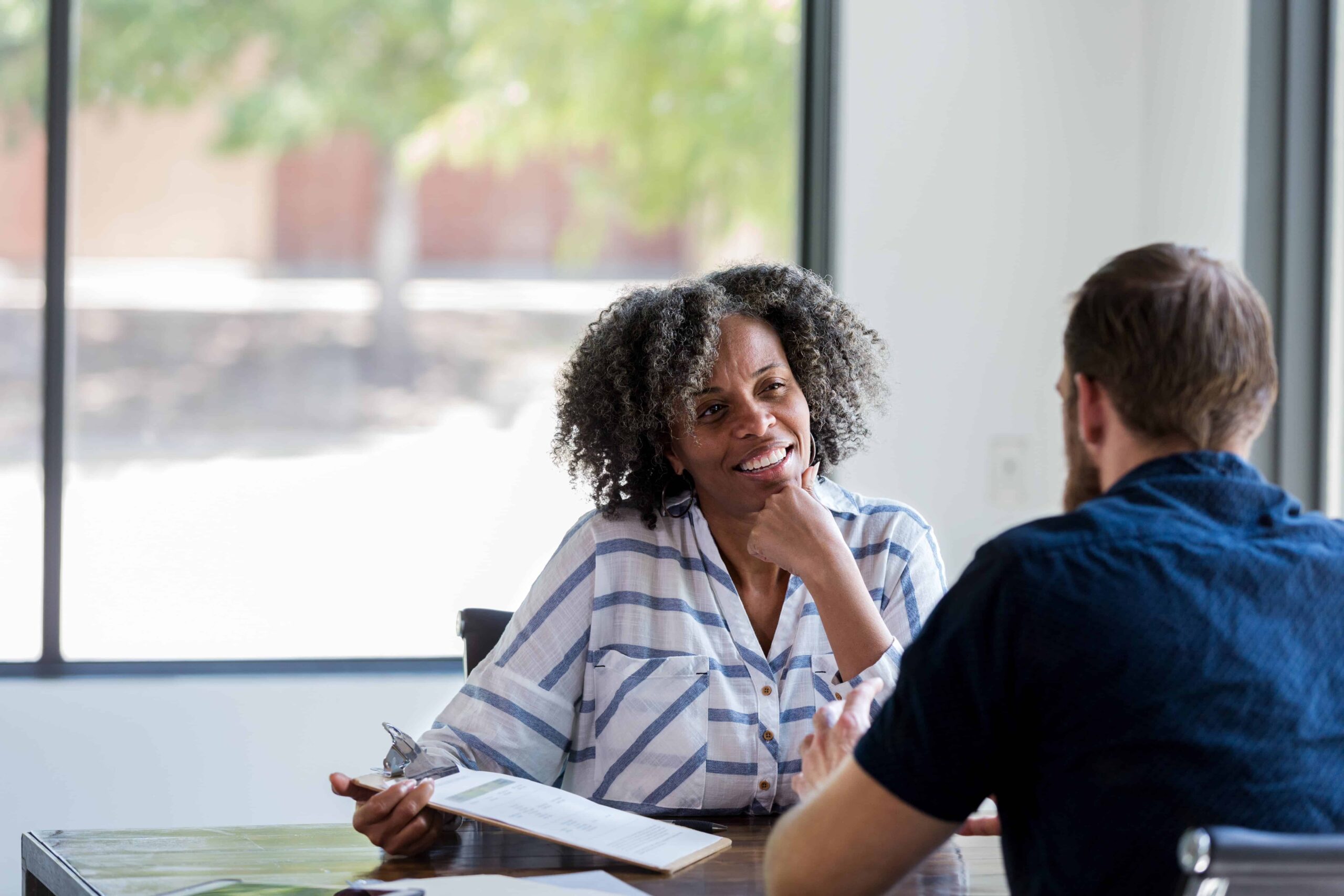 Mature businesswoman talks with male colleague