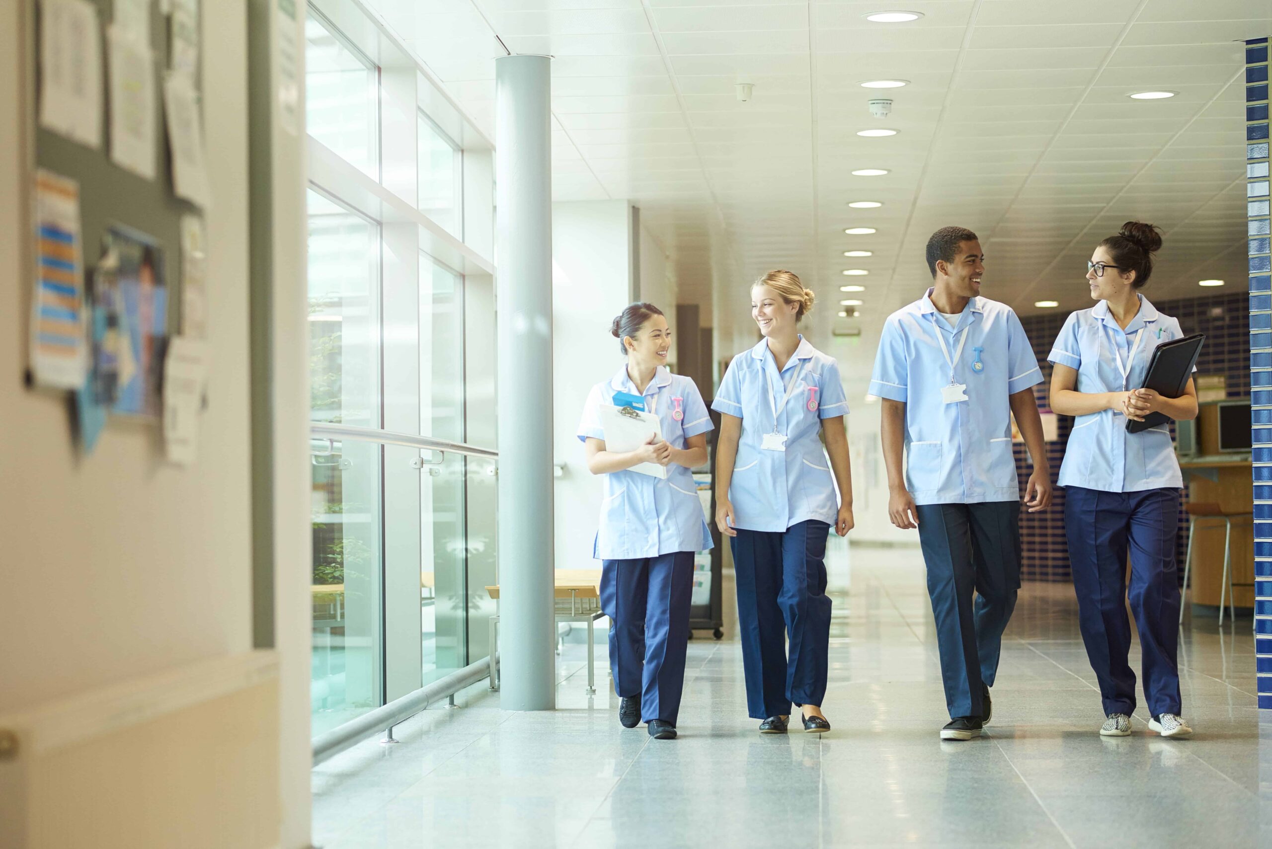 happy young nurse team . A group of nursing students walking down a corridor
