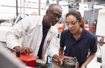 a student learning how to use machinery