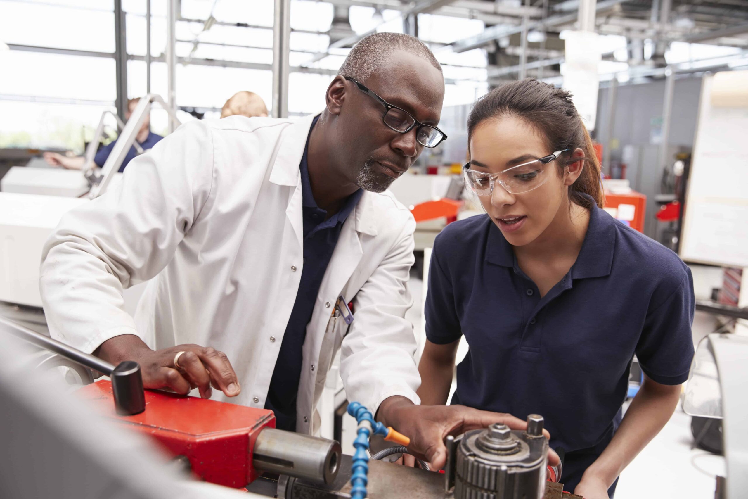 a student learning how to use machinery