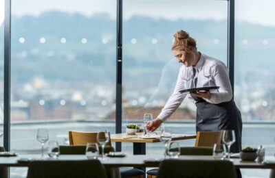 A petroc hospitality and catering student waitering tables