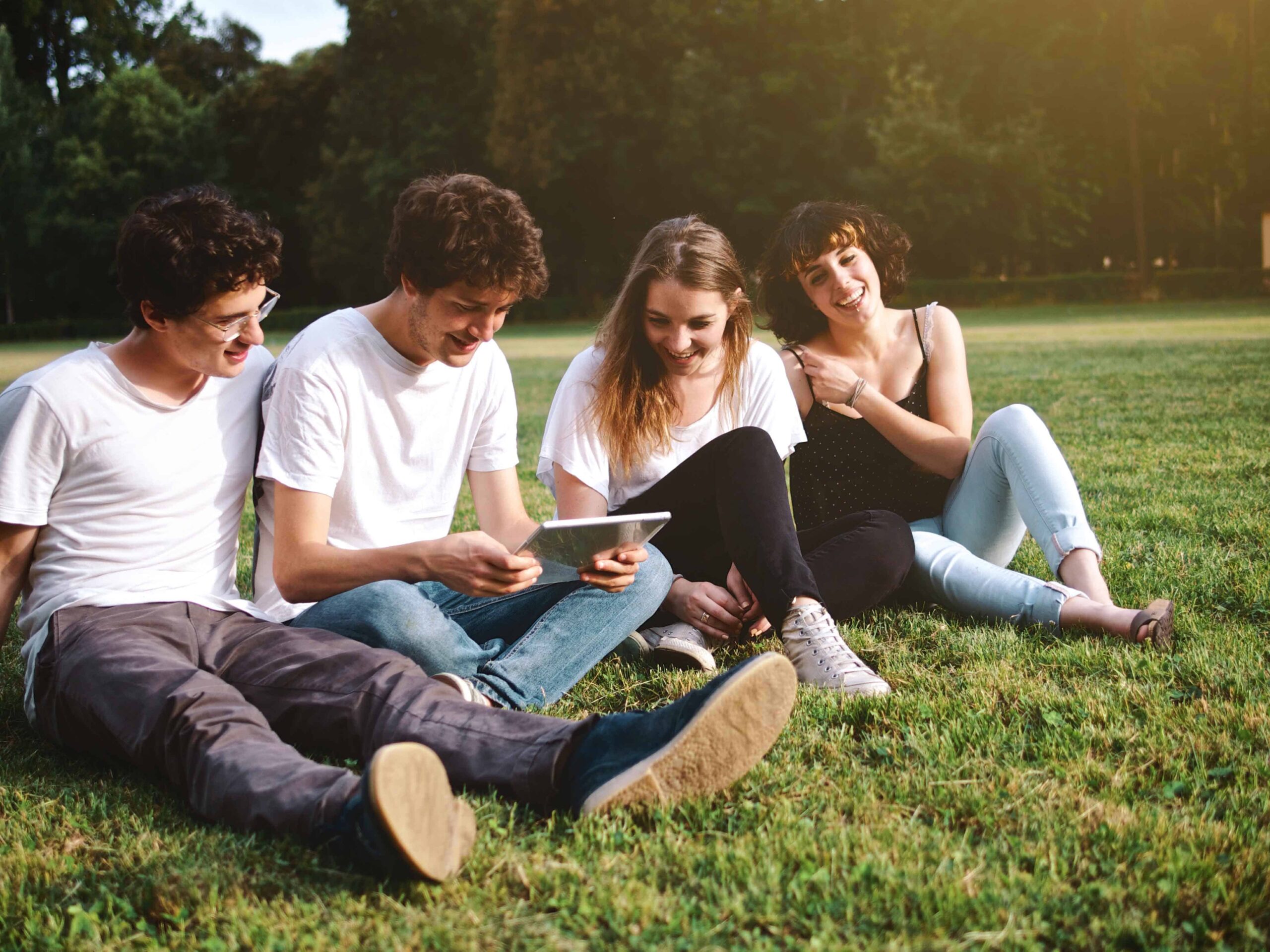 Group of college students at campus using a digital tablet ASPIRE