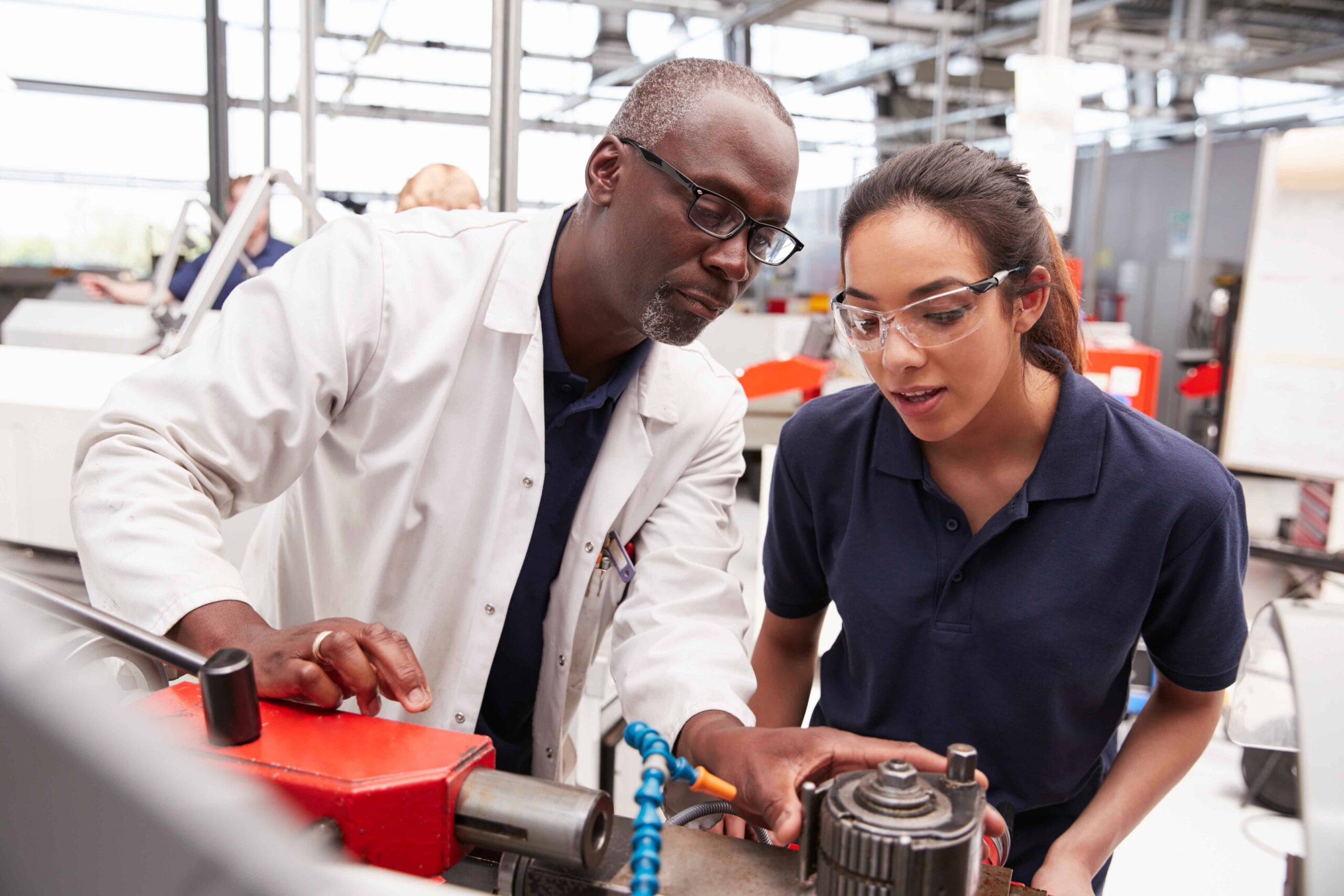 Engineer demonstrating to a work experience student