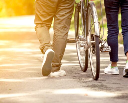 A student pushing a bicycle