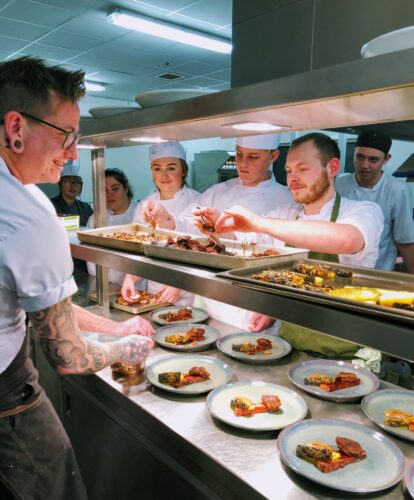 Hospitality and catering students preparing food in the Taw Restaurant