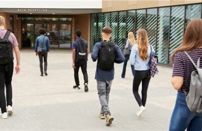 A group of students walking towards the campus