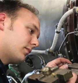 An apprentice working on some machinery