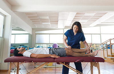 A therapist giving a client a sports massage