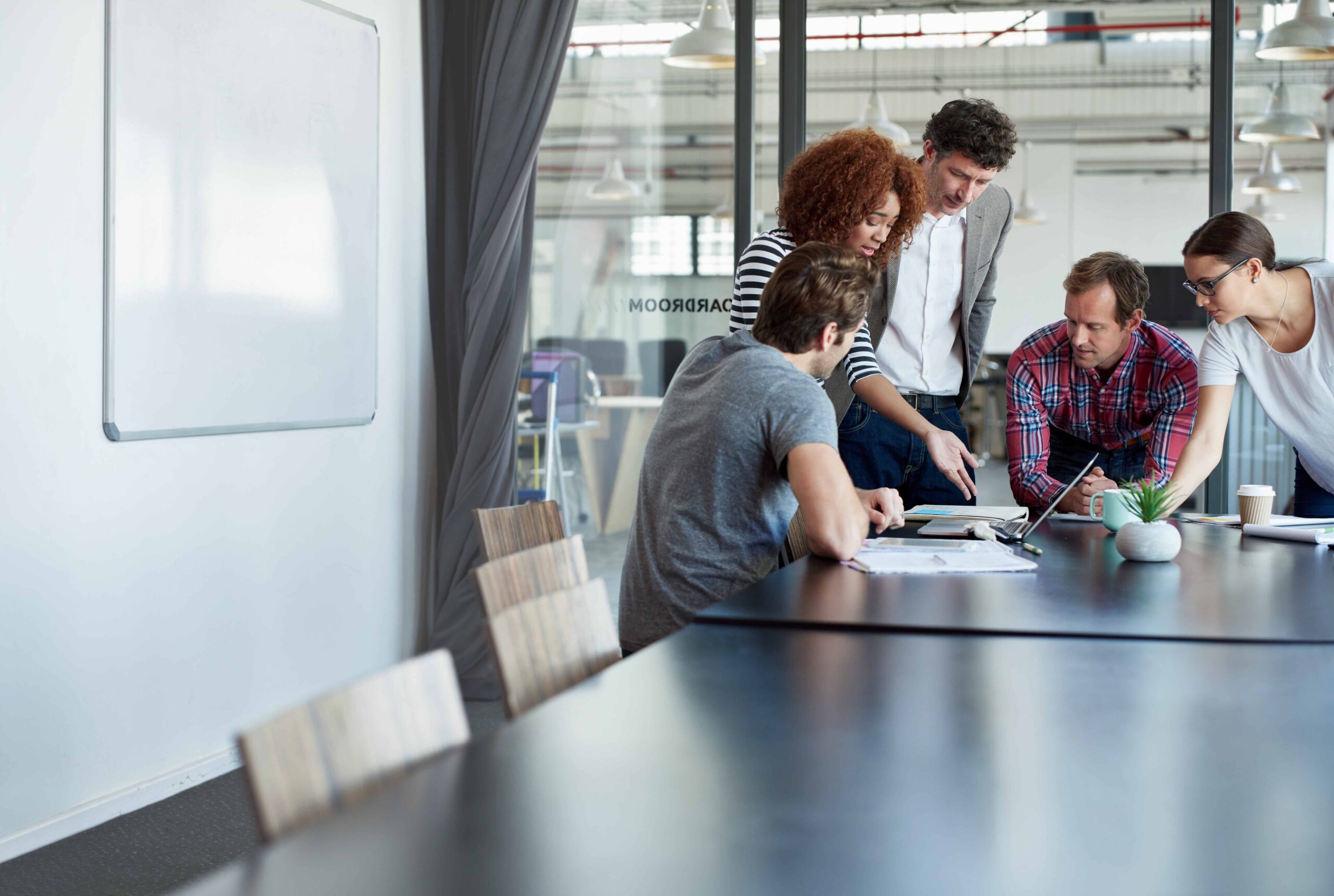 A group of students looking at work on a screen