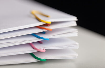 File folders with documents and bright paperclips