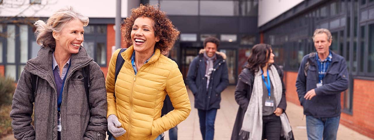 a group of adults learners outside campus