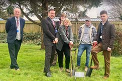 A group of Petroc staff and students planting a tree to commemorative the Queens Jubilee