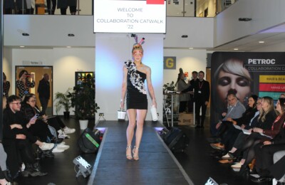 A student walking down the catwalk for the collaboration catwalk