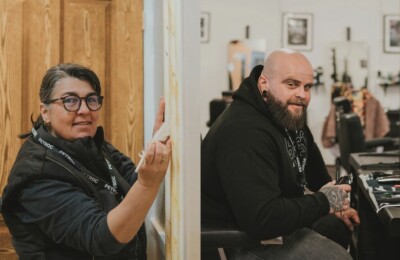 Two adult learners, one painting a frame and one in a barber shop