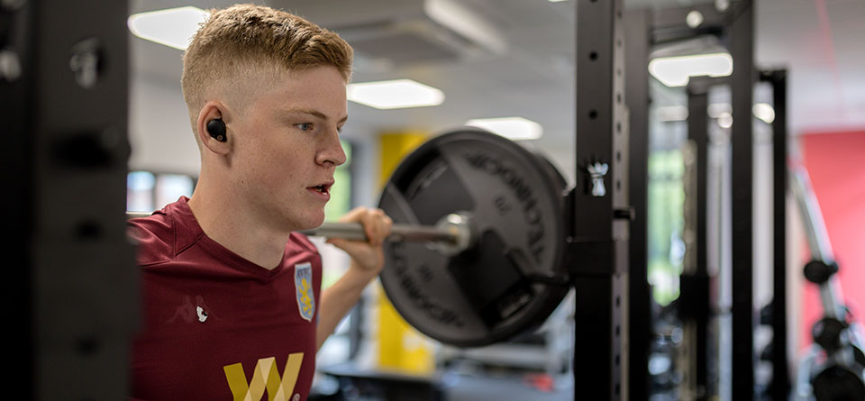 man lifting weights in gym
