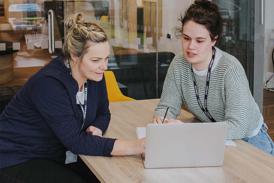 Two women working on laptops