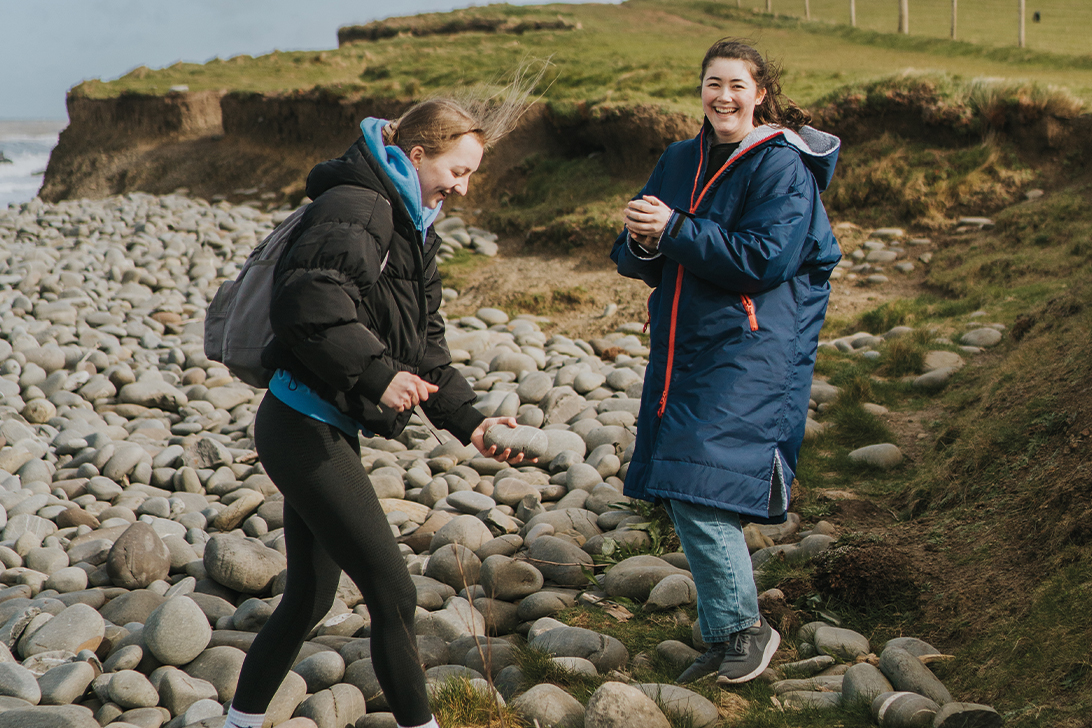 two education and childcare students on the beach