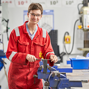 Student using a tool in a workshop
